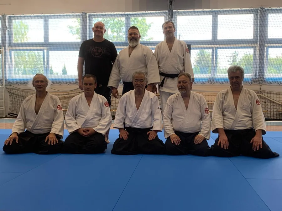 Tomasz Kuszewicz smiling with a fellow martial arts practitioner